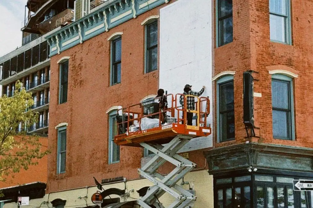 Masons working on a brick building facade in New York City