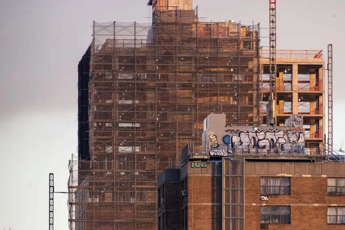 High-rise building under construction with scaffolding in New York